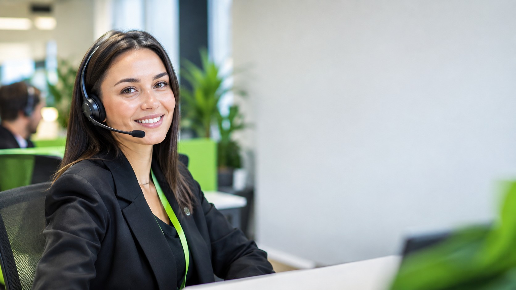Friendly support agent with a headset in a bright modern office